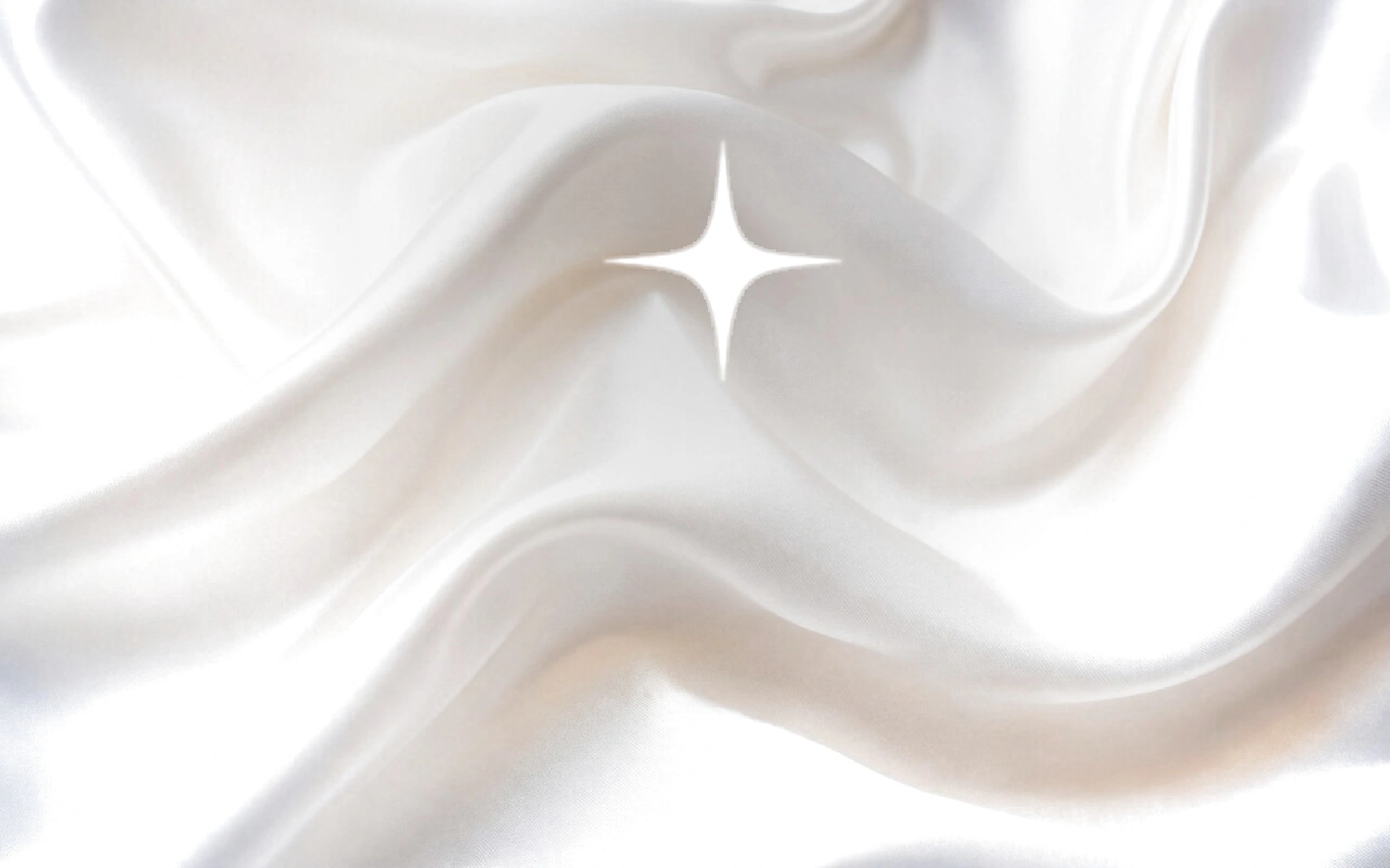 Radiant white silk satin in soft folds, with a bright four-pointed star of light on the crest.